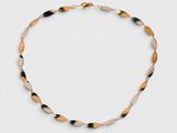 a close up of a necklace on a white surface