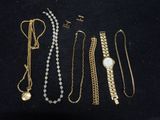 a group of jewelry including a watch, bracelets and a necklace