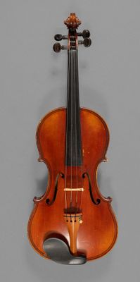 an old violin sitting on top of a gray surface