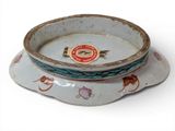 a white bowl with a blue and red design on it