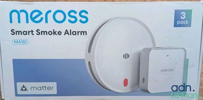 the box of a smart smoke alarm is sitting on the table