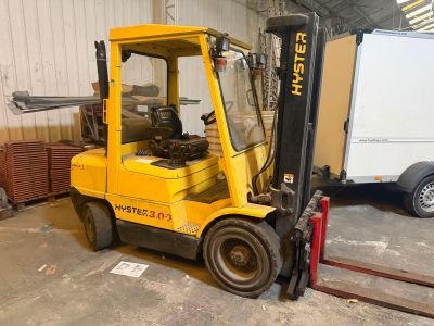 a yellow forklift truck parked in a warehouse