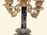 a blue and gold candelier with three candles on it