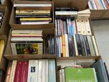 many books in a box on the floor