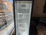 a refrigerator that is sitting in the corner of a building