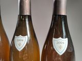 three bottles of wine sitting on top of a table next to each other