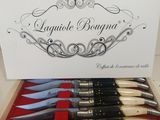 five knives in a box with a name on it