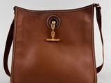 a brown handbag with a gold chain on the handle