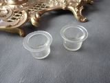 pair of clear glass candlestick holders sitting on top of a table