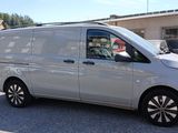 a silver van that is parked in a parking lot