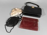 a black purse and a red purse on a white table