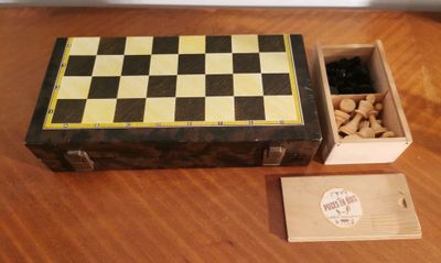 a wooden box with a checker board and a box of nuts