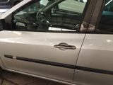 a silver car parked in a parking lot with other cars in the background