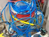 a pile of hoses and other equipment in a garage