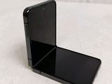a black cell phone sitting on top of a table