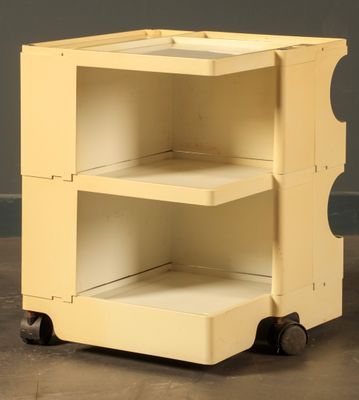 an image of a yellow cart with three shelves on wheels