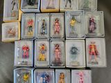 a lot of action figures in the boxes on the couch