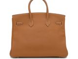 a brown leather handbag on a white background
