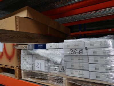 a large stack of boxes on a pallet in a warehouse