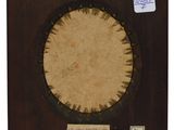 an old photo of a wooden frame with a picture of a sun