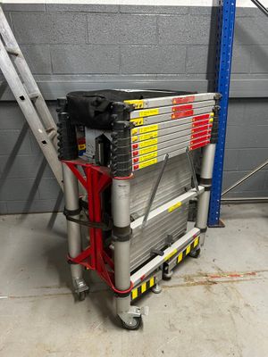 a ladder that is sitting in front of a building