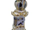 a blue and white vase with a bird on top of it