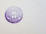 a picture of a purple and white logo on a piece of paper