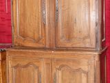 une grande armoire en bois avec un mur rouge en arrière-plan