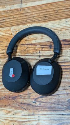 a pair of headphones sitting on top of a wooden table