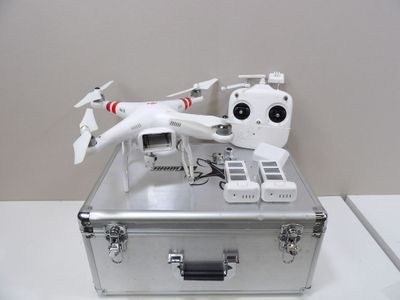 a silver case with a remote control system on top of it