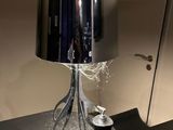 a table with a lamp and a cup on it