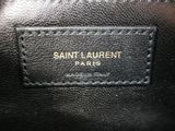 a close up of a black bag with a gold logo on it