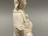 an image of a statue of a woman holding a baby