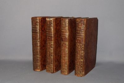 three old books sitting on top of each other on a table