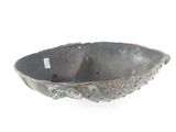 a metal bowl that is sitting on a white surface