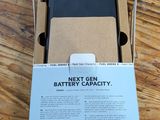 the box is open on a wooden table with a phone in it