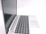 a white laptop with a black keyboard on a white surface