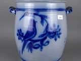 a blue and white vase with a bird on it
