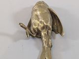a silver elephant figurine sitting on a white surface