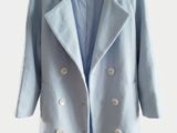 a picture of a light blue coat hanging on a hanger