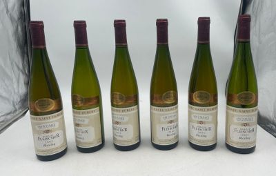 six bottles of wine are lined up on a table