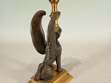 brass candle holder with a squirrel on a base
