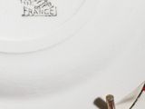 a close up of a plate with a red and white stripe