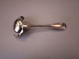 a spoon and spoon rest on a table
