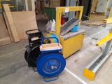 a blue and yellow machine that is sitting on the ground