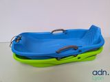 a blue and green bath tub sitting on a table
