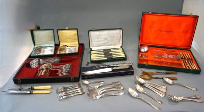 many different types of silverware on display on a table