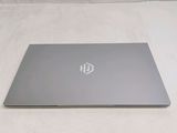 the laptop is open on a white surface with a logo on it