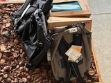 two backpacks and a backpack bag on the ground