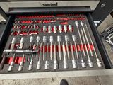 a man standing in front of a drawer full of tools